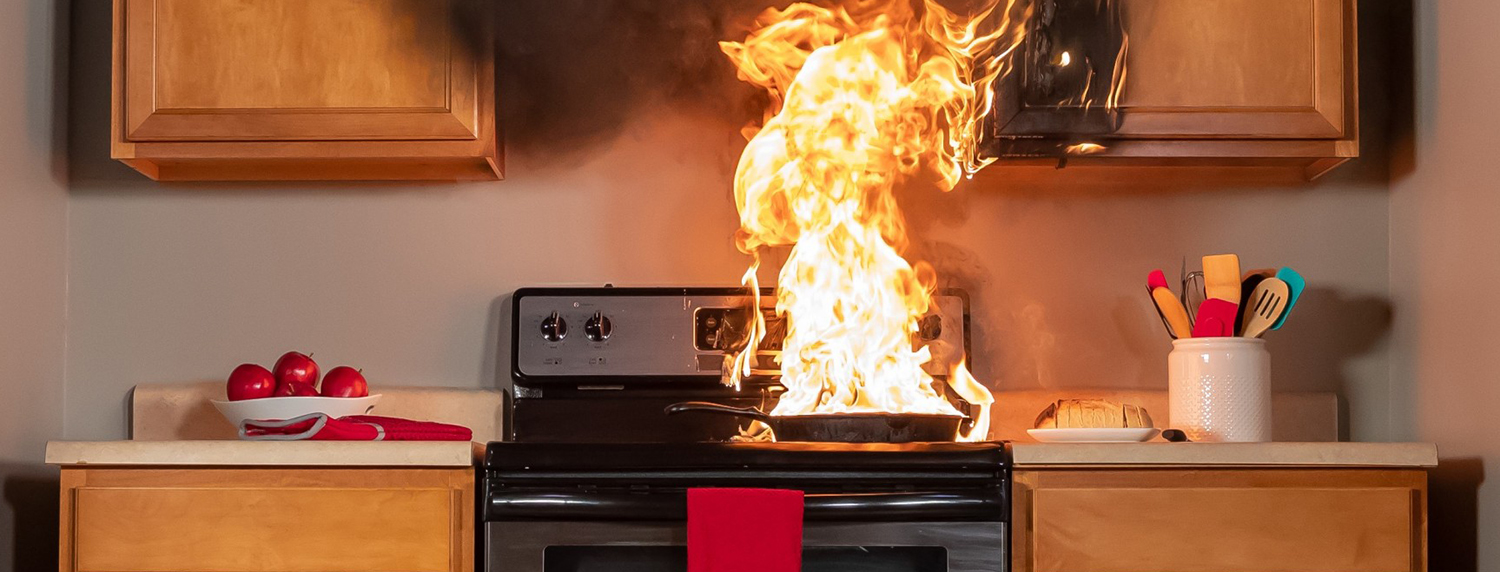 Fire in pan on kitchen stove